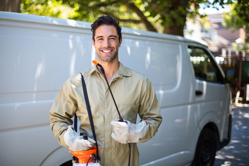 Smiling Milberger exterminator worker with pesticide sprayer PestControlAdobeStock_107521558_Digital advertising REAL Moxie LLC_WavebreakmediaMicro